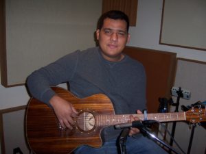 Isaias Rivera plays acoustic guitar