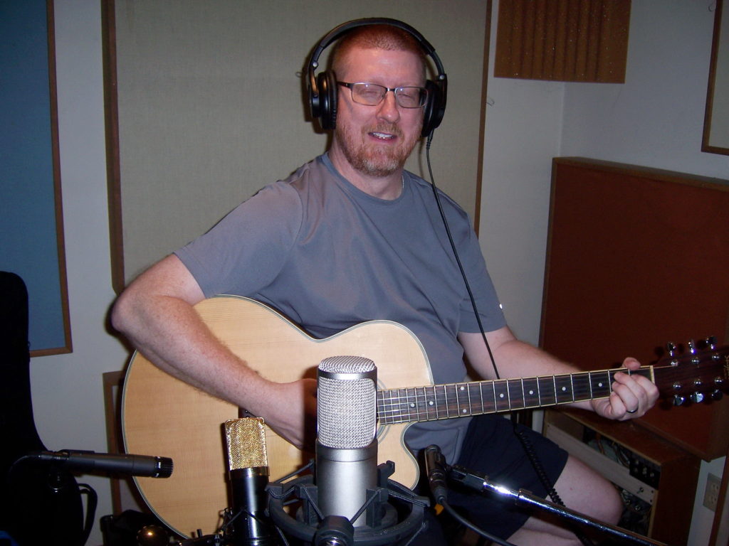 Stephen Tefft playing acoustic guitar.