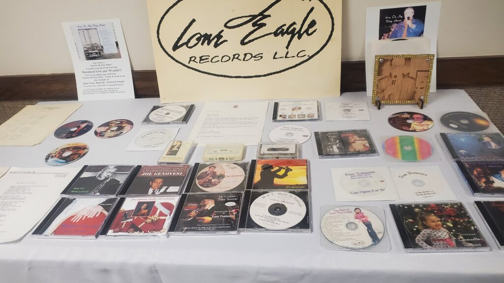 A sampling of Tom Tomoser Sr.'s music releases on display at his funeral.
